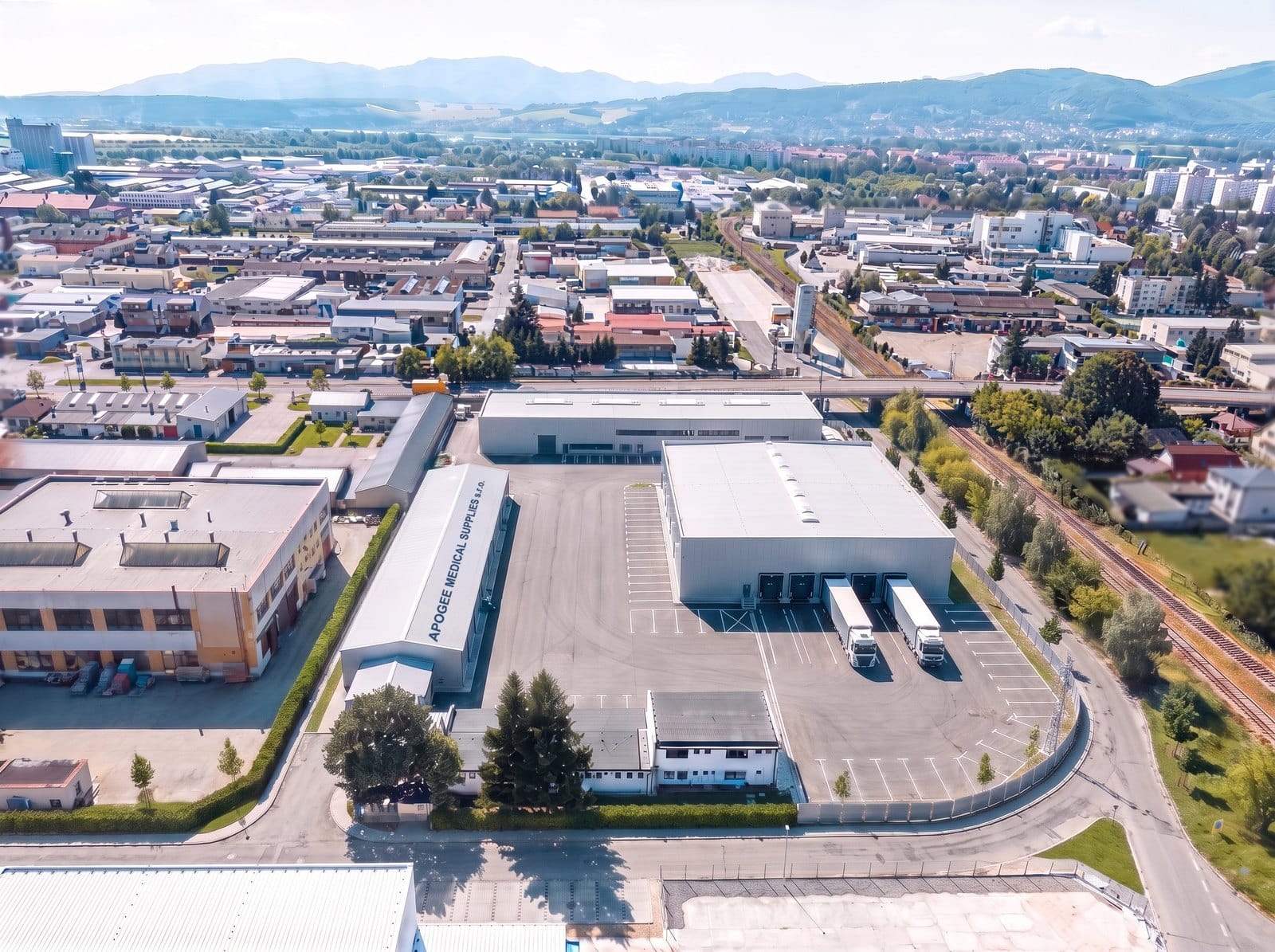 Computer-generated aerial view of the Apogee Medical Supplies site in Nitra, Slovakia: warehouse, dispatch bays and lorries